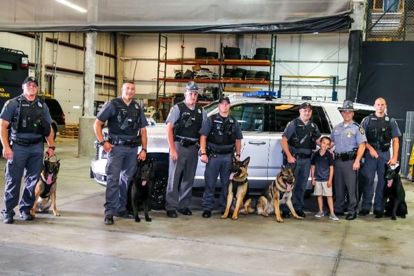 Brady with Some of the Vests Provided by Brady's K9 Fund