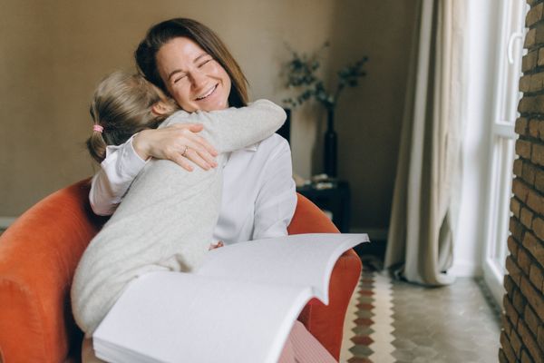 A mother hugging her daughter