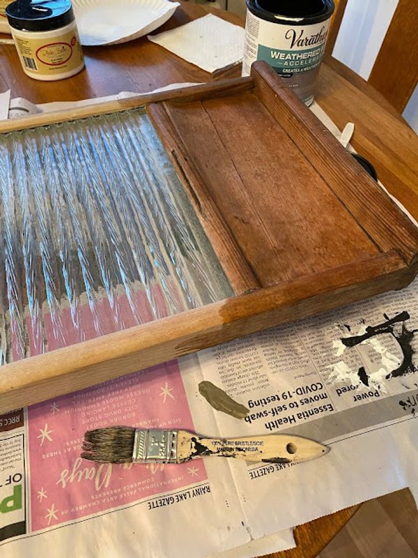 Thrifted Washboard Farmhouse Makeover Photo of Weathered Wood Accelerator being applied to the wood on an old washboard.