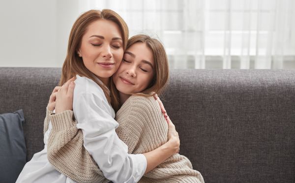 Mother hugging her teenage daughter